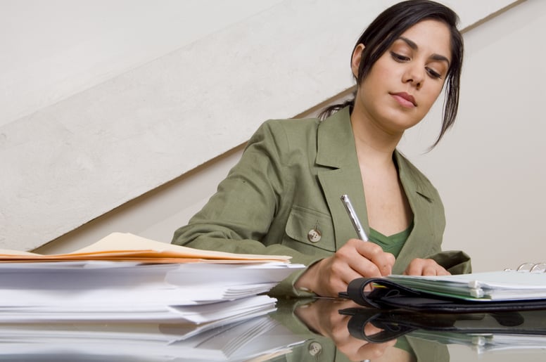Businesswoman filling out paperwork