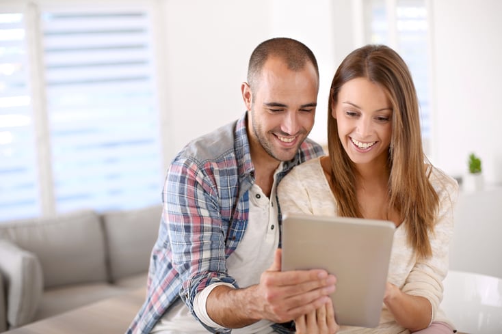 Young couple at home websurfing on internet