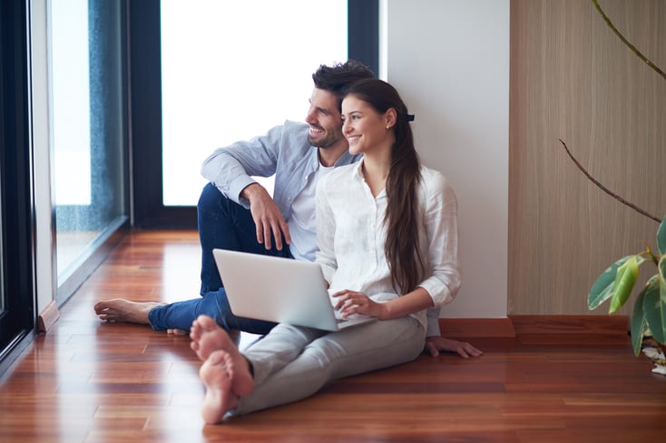 happy young relaxed  couple working on laptop computer at modern home interior-1