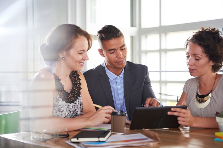 team of successful business people having a meeting in executive sunlit office