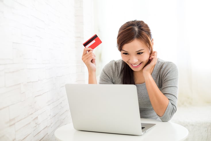 Girl on computer with credit card