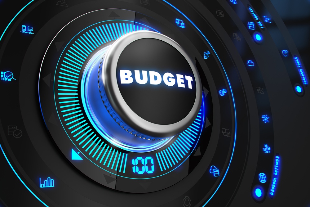 Budget Controller on Black Control Console with Blue Backlight. Improvement, regulation, control or management concept.