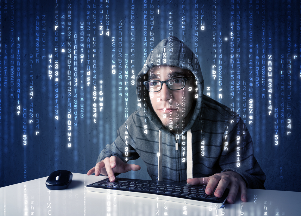 Hacker decoding information from futuristic network technology with white symbols