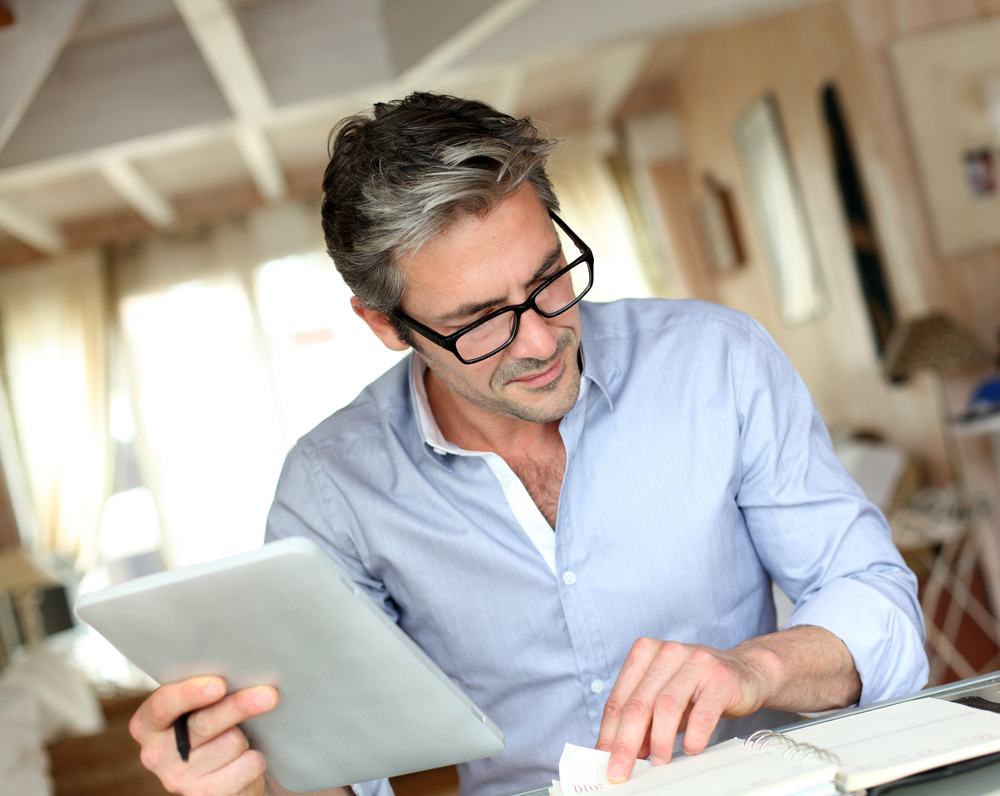 Handsome businessman with eyeglasses working from home