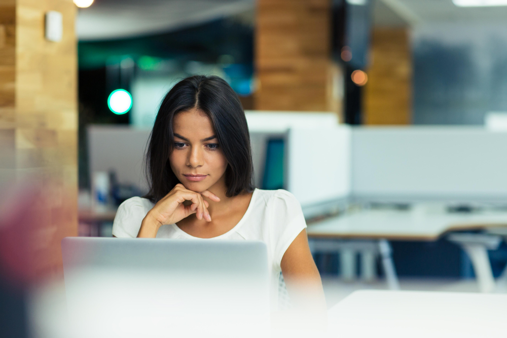 Portrait of a serious businesswoman using laptop in office