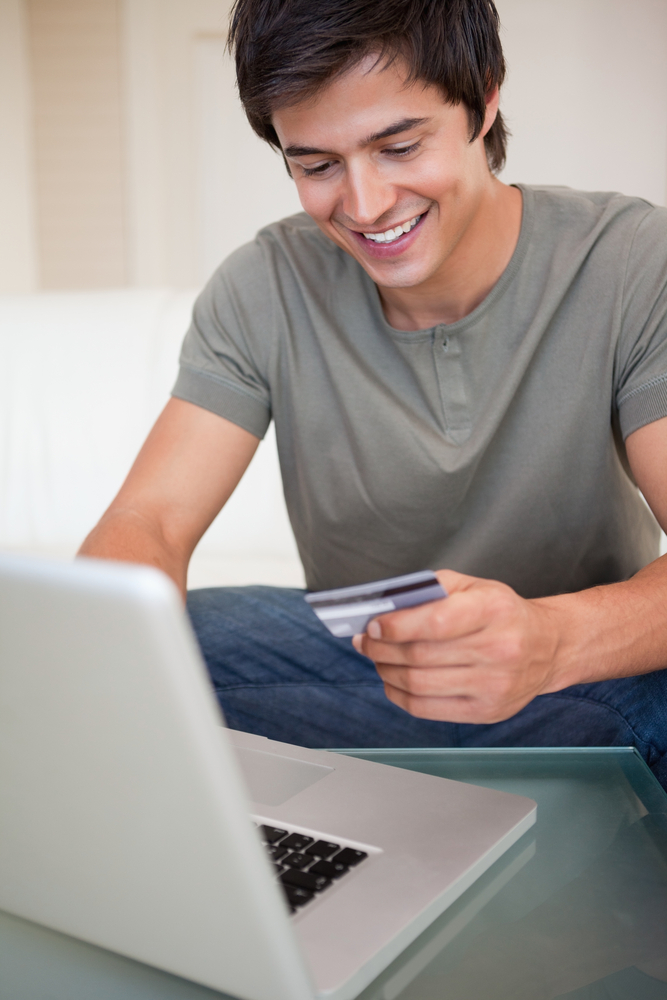 Portrait of a young man shopping online in his living room